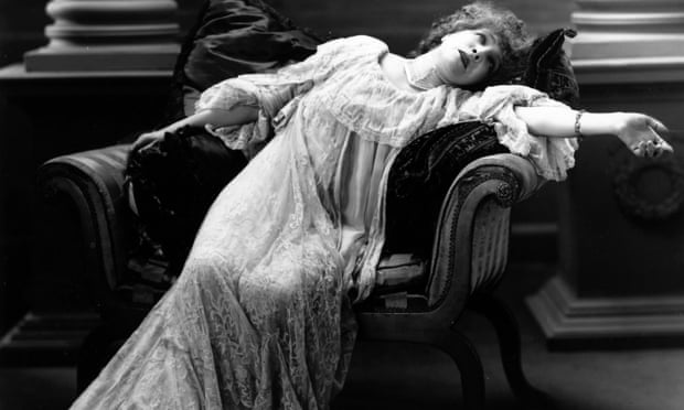 A black and white photograph of Sarah Bernhardt reclining dramatically in an armchair.